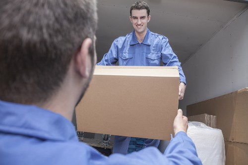 Removal team handling boxes outside a Chelsea townhouse