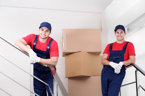 Removal team preparing a Chelsea house move with packing materials