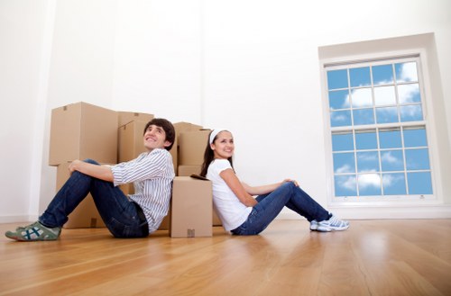 Professional movers handling furniture in a Chelsea property