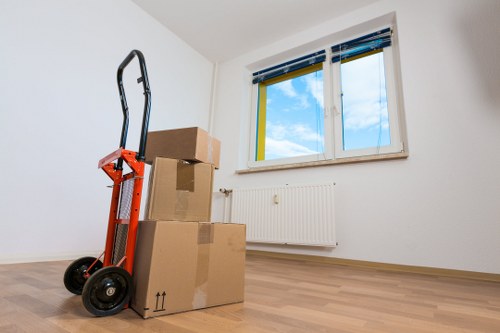 Furniture being carried carefully through a Chelsea home entryway